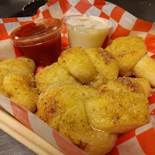 Garlic knots with parmesan cheese and herbs, served with marinara and garlic dipping sauces.